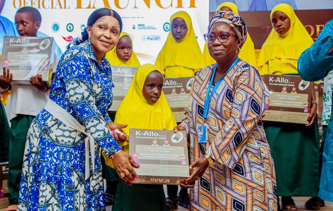 Presenting a K-Allo tablet to a young pupil