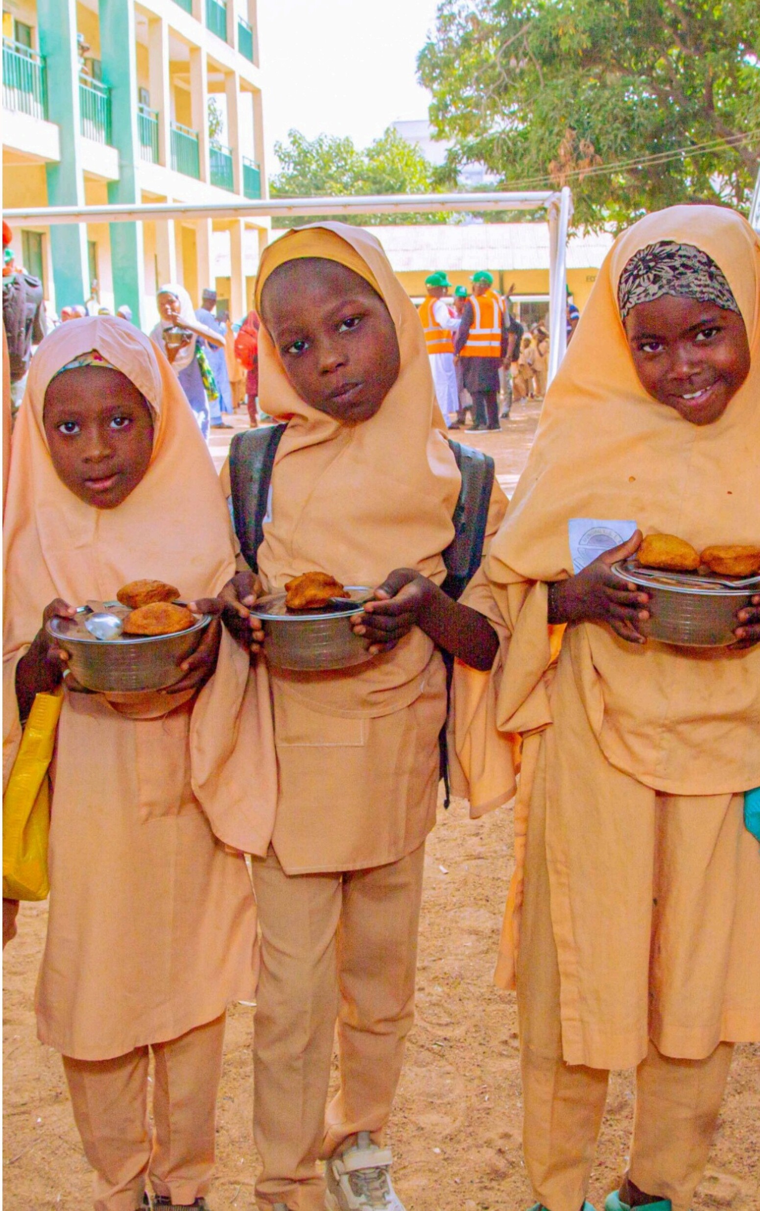 Dr. Adebowale serving meals to pupils