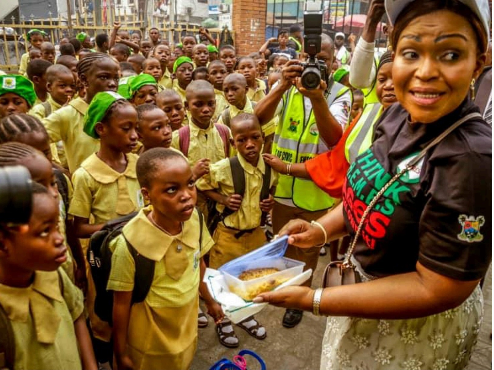Dr. Adebowale handing meals to pupils